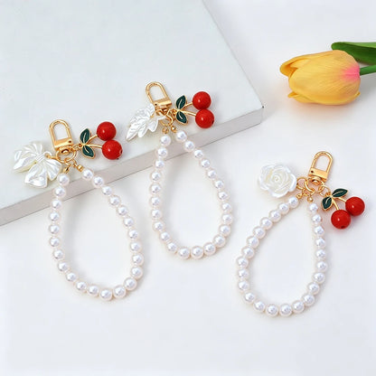 Elegant Imitation Pearl Wrist Phone Lanyard with Cherry Pendant Cute Bow Leaf Keychain Bag Charm Anti-lost Phone Strap for Women