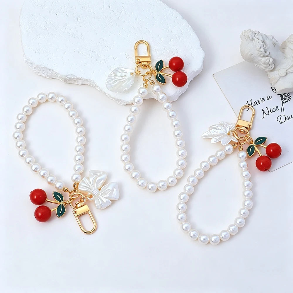 Elegant Imitation Pearl Wrist Phone Lanyard with Cherry Pendant Cute Bow Leaf Keychain Bag Charm Anti-lost Phone Strap for Women