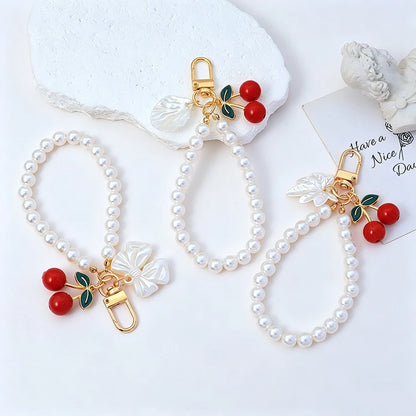 Elegant Imitation Pearl Wrist Phone Lanyard with Cherry Pendant Cute Bow Leaf Keychain Bag Charm Anti-lost Phone Strap for Women
